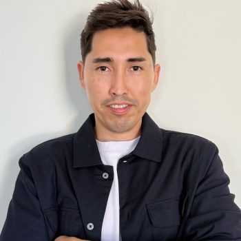 Teacher David Sierra looks into the camera with confidence and folden arms